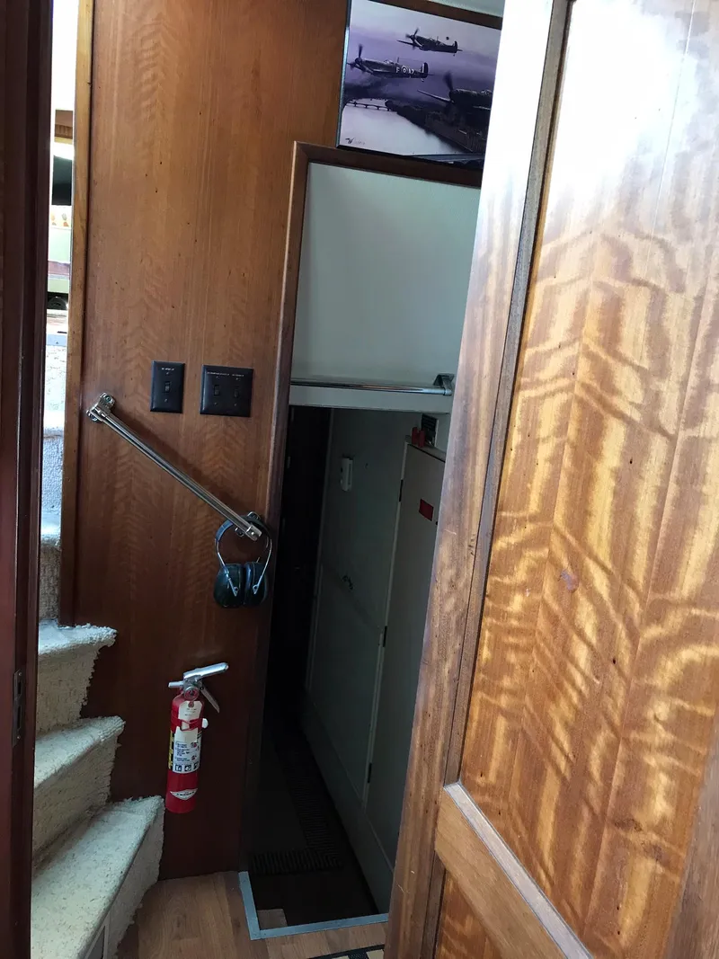 Slide: The Image of Interior of 1978 Hatteras 58 MY yacht with wooden paneling and stairs. - 64