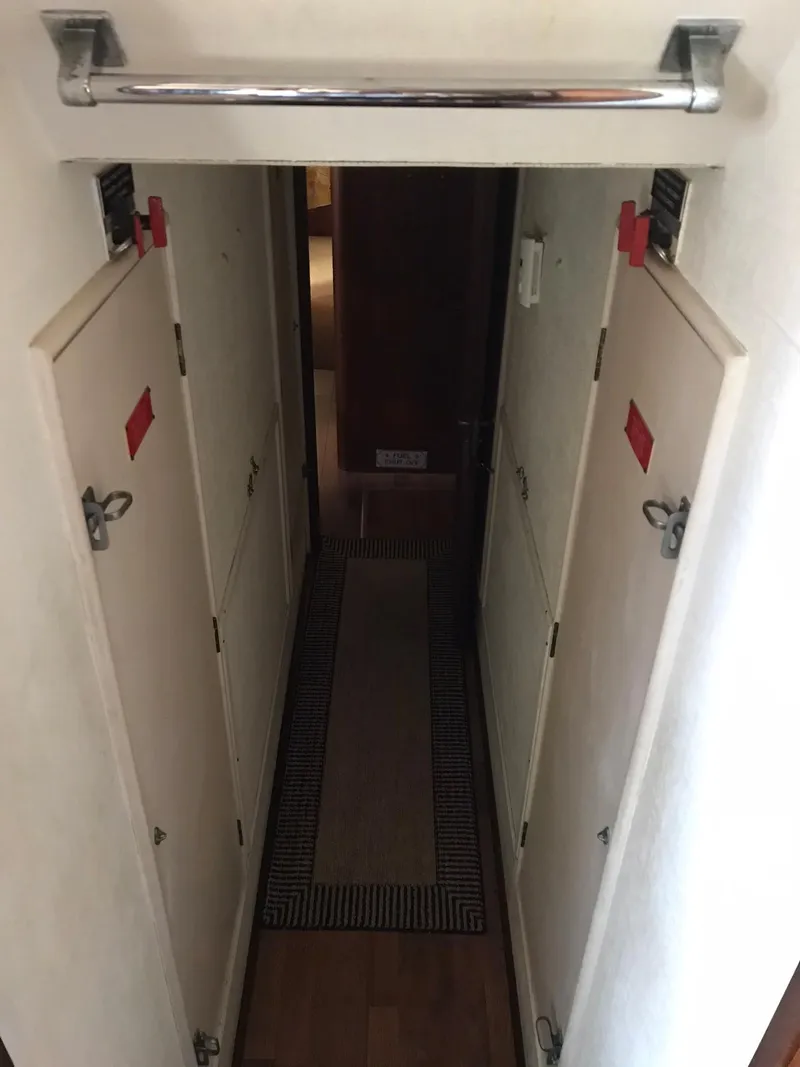 Slide: The Image of Narrow hallway inside a 1978 Hatteras 58 MY yacht with closed doors. - 66