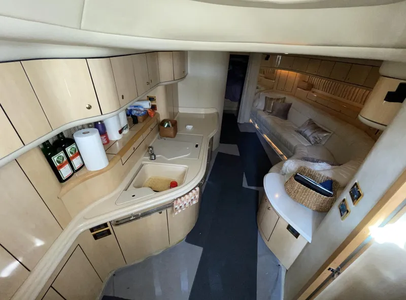 Slide: The Image of Interior of 2000 Sea Ray 540 Sundancer yacht with kitchen and lounge area. - 11