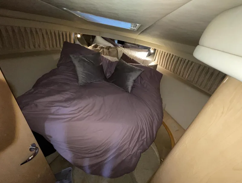Slide: The Image of Cozy bedroom in 2000 Sea Ray 540 Sundancer yacht with skylight and plush bedding. - 15