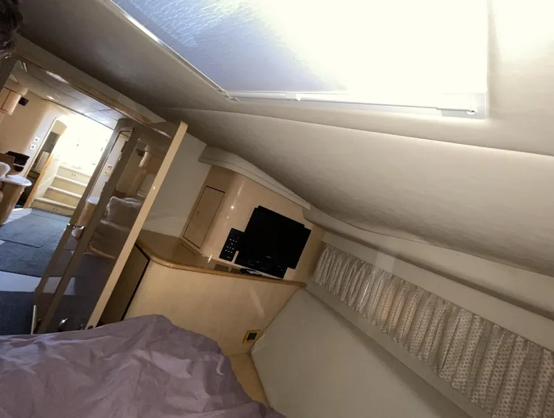 Slide: The Image of Interior cabin of 2000 Sea Ray 540 Sundancer yacht with TV and bed. - 16