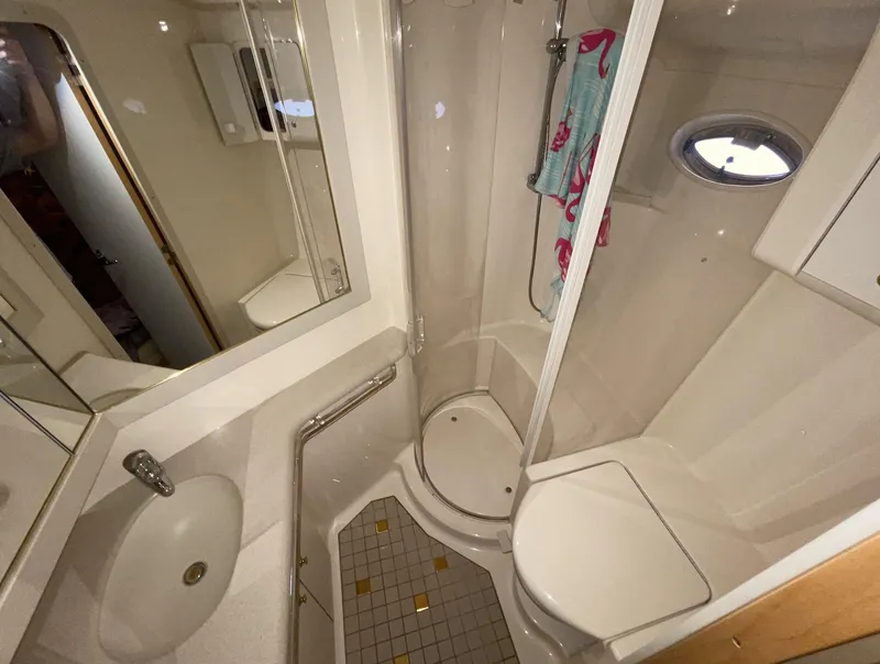 Slide: The Image of Compact bathroom in 2000 Sea Ray 540 Sundancer yacht with shower, sink, and toilet. - 18