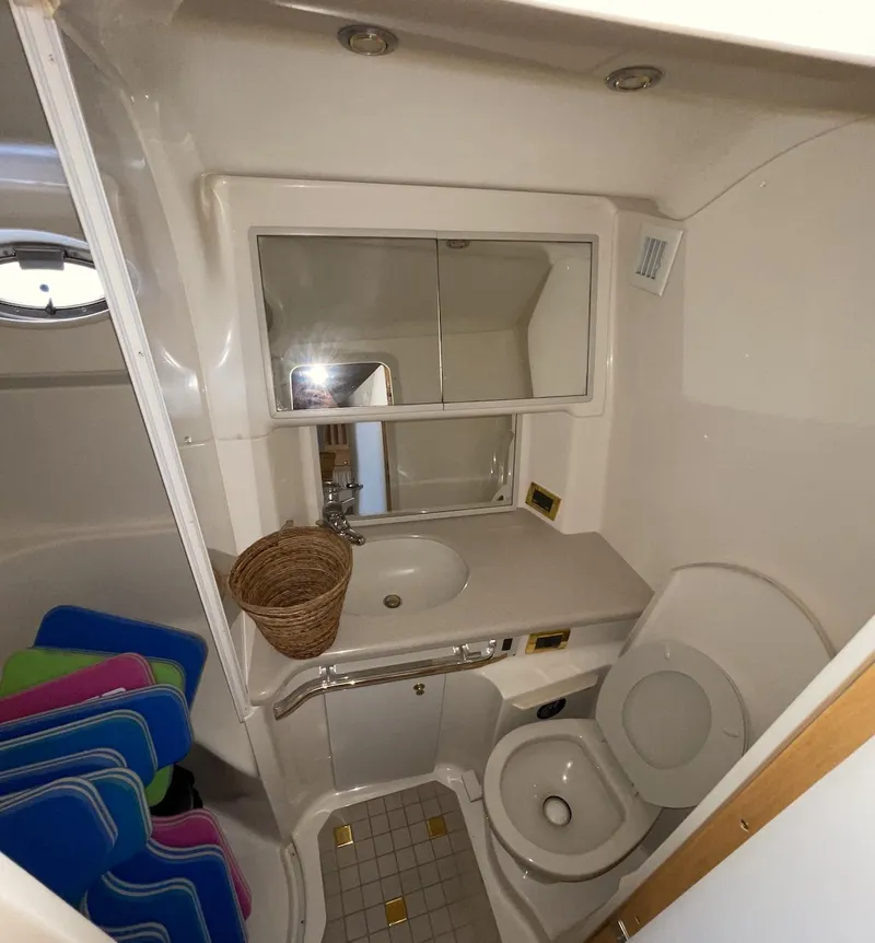 Slide: The Image of 2000 Sea Ray 540 Sundancer bathroom with sink, toilet, mirror, and storage. - 19