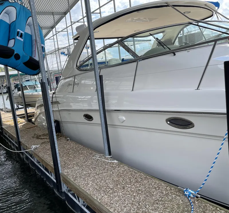 Slide: The Image of 2000 Sea Ray 540 Sundancer docked at a marina under a covered slip. - 3