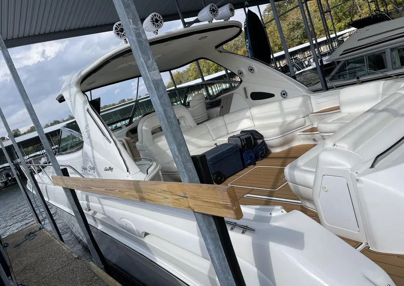 Slide: The Image of 2000 Sea Ray 540 Sundancer yacht docked at marina, spacious deck and seating area. - 4