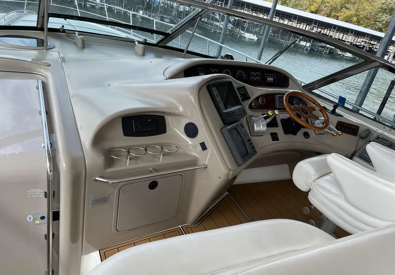 Slide: The Image of 2000 Sea Ray 540 Sundancer helm with modern controls and wood accents. - 7