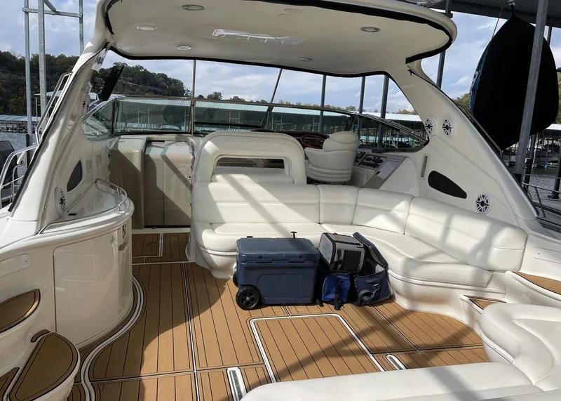 Slide: The Image of Interior of 2000 Sea Ray 540 Sundancer yacht with white seating and wooden flooring. - 9