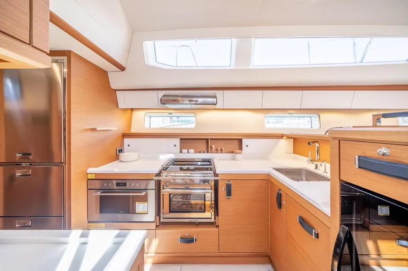 Slide: The Image of Modern kitchen in 2023 Jeanneau 65 yacht with stainless steel appliances and ample natural light. - 11