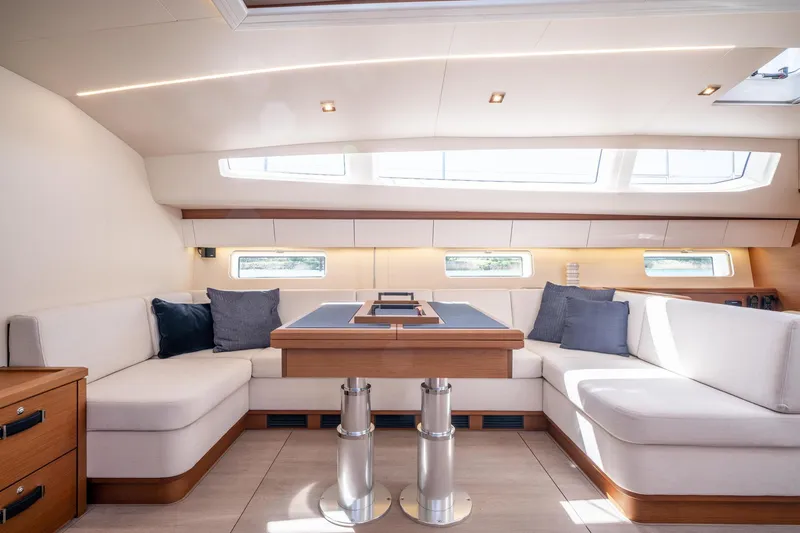 Slide: The Image of Luxurious interior of 2023 Jeanneau 65 yacht with modern seating and natural light. - 20