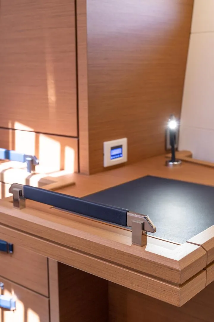 Slide: The Image of 2023 Jeanneau 65 yacht interior desk with modern lighting. - 5