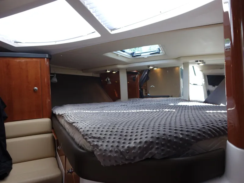 Slide: The Image of Interior cabin of 2011 Regal 35 Express Cruiser with skylight and cozy bedding. - 13