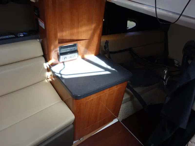 Slide: The Image of Interior of a 2011 Regal 35 Express Cruiser with beige seating and wooden cabinetry. - 16
