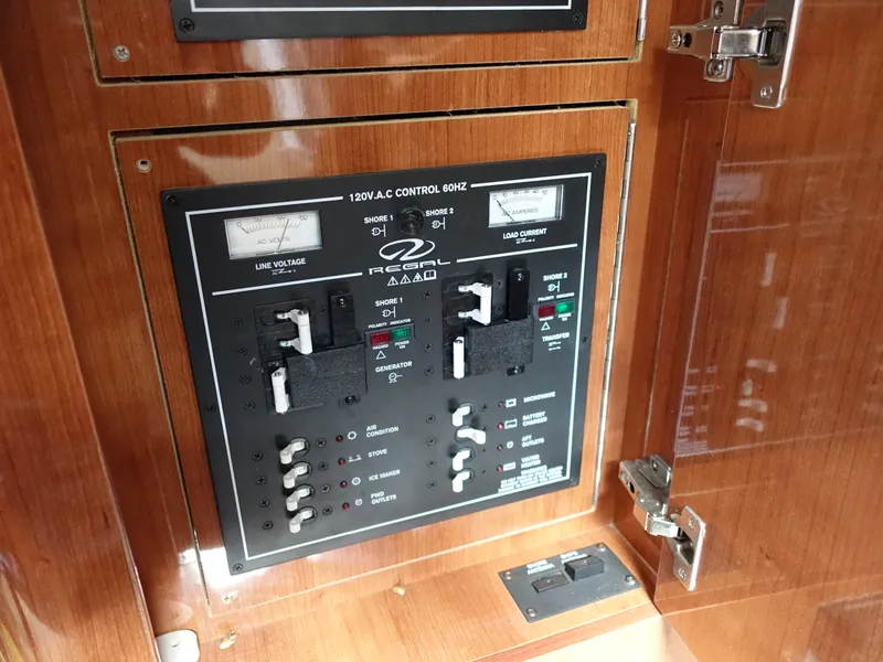 Slide: The Image of Electrical control panel on 2011 Regal 35 Express Cruiser yacht, featuring switches and meters. - 20