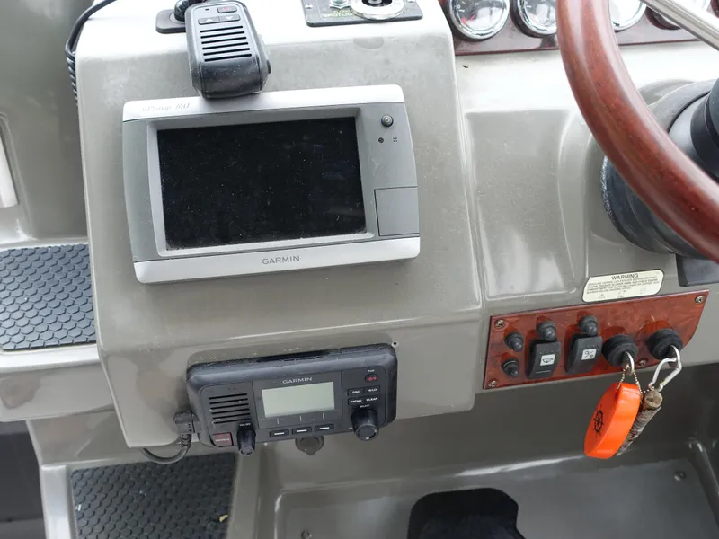 Slide: The Image of Control panel of a 2011 Regal 35 Express Cruiser with Garmin navigation equipment. - 4