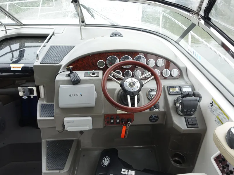 Slide: The Image of 2011 Regal 35 Express Cruiser helm with Garmin navigation and wood-accented steering wheel. - 5