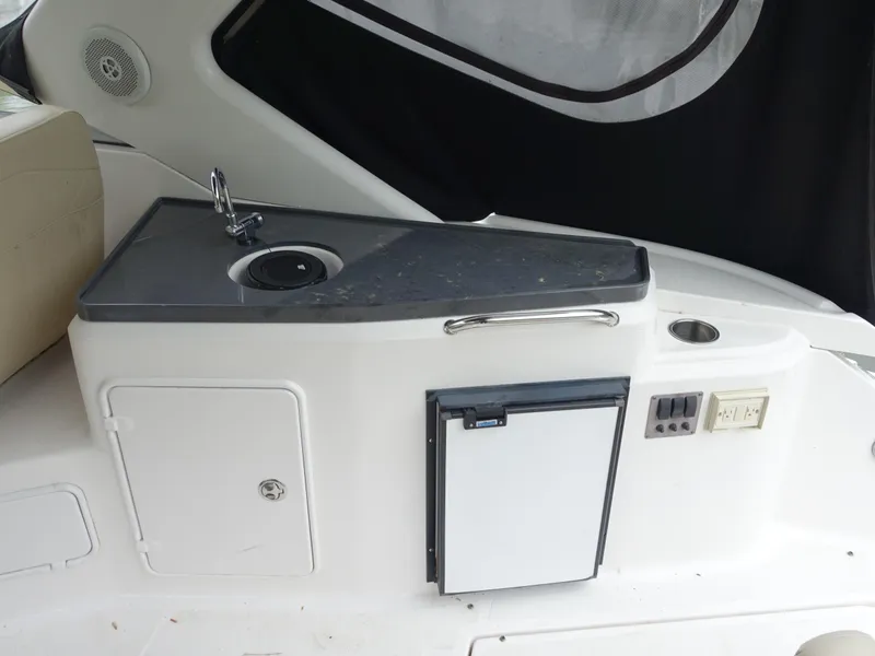 Slide: The Image of 2011 Regal 35 Express Cruiser interior with sink and mini fridge. - 6