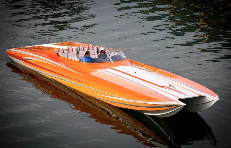 Slide: The Image of 2017 Nordic 43' Enforcer speedboat in orange and white on water. - 10