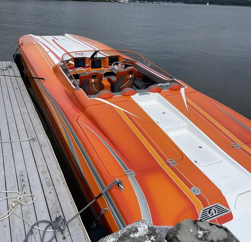 Slide: The Image of 2017 Nordic 43' Enforcer speedboat docked, vibrant orange and white design. - 13