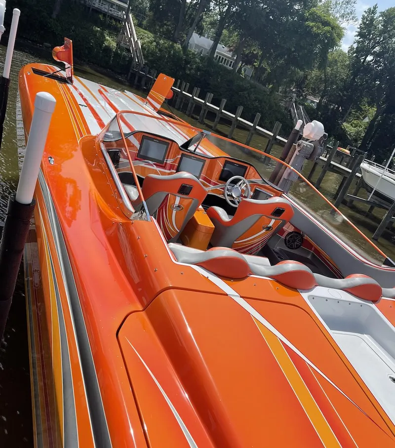 Slide: The Image of Bright orange 2017 Nordic 43' Enforcer speedboat docked by the water. - 19