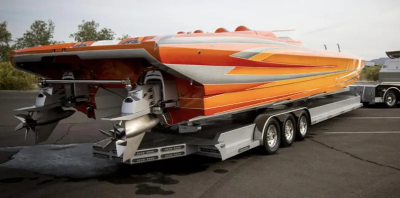 Slide: The Image of 2017 Nordic 43' Enforcer speedboat on a trailer, featuring an orange and silver design. - 23