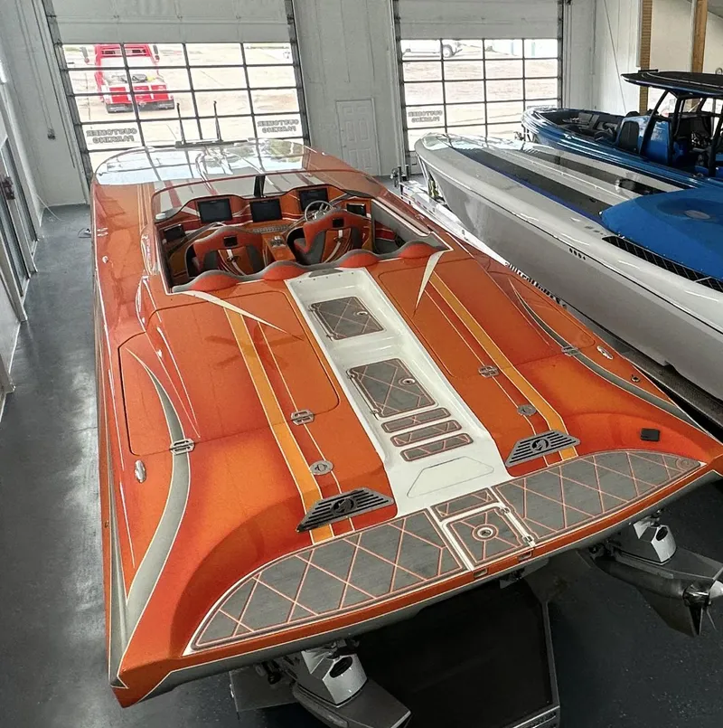 Slide: The Image of Orange 2017 Nordic 43' Enforcer speedboat in showroom, sleek design, luxury performance. - 7
