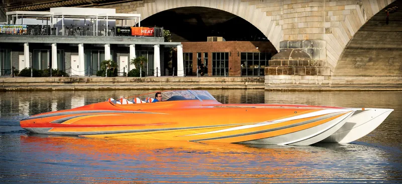 Slide: The Image of 2017 Nordic 43' Enforcer speedboat on calm water near a bridge. - 9