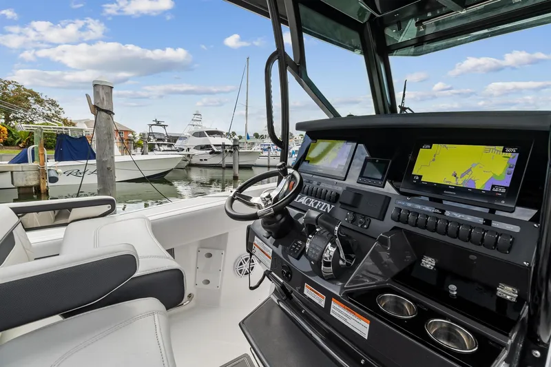 Slide: The Image of 2022 Blackfin 272 CC boat dashboard with navigation system at marina. - 11