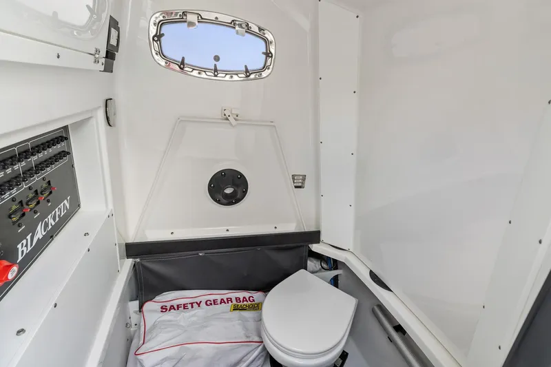 Slide: The Image of 2022 Blackfin 272 CC boat interior with toilet and safety gear bag. - 14