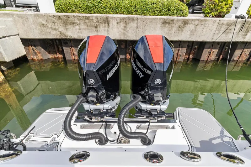 Slide: The Image of 2022 Blackfin 272 CC with twin Mercury outboard engines docked. - 3