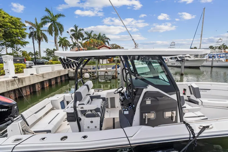 Slide: The Image of 2022 Blackfin 272 CC boat docked at marina with palm trees and yachts. - 4