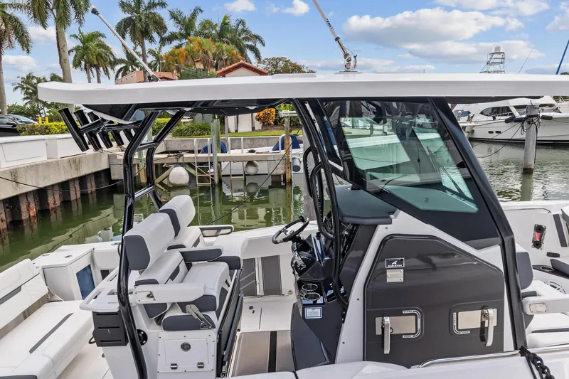 Slide: The Image of 2022 Blackfin 272 CC boat docked at a marina with palm trees in the background. - 5