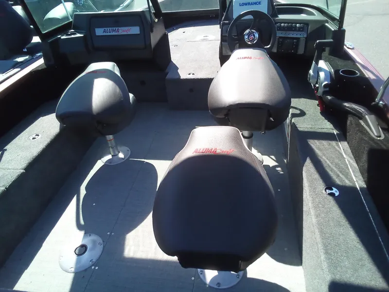 Slide: The Image of 2023 Alumacraft Competitor 175 Sport boat interior with seating and control panel. - 4