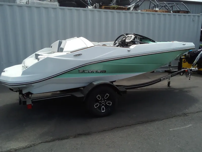 Slide: The Image of 2023 Scarab 165 ID boat on a trailer in a storage area. - 2