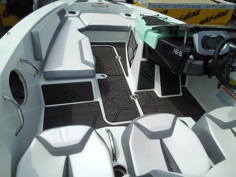 Slide: The Image of 2023 Scarab 165 ID boat interior with white and gray seating. - 6