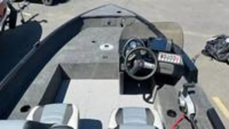 Slide: The Image of 2022 Alumacraft Classic 165 CS fishing boat interior with steering console and seating. - 5