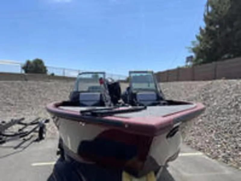 Slide: The Image of 2022 Alumacraft Competitor 205 Sport boat in a parking lot. - 2