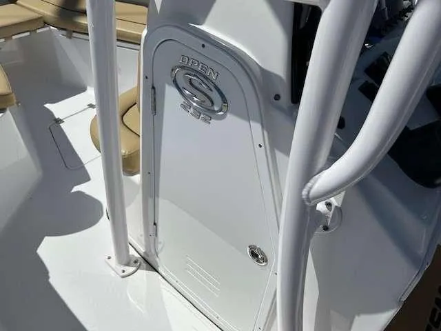 Slide: The Image of 2023 Sportsman 232 Open boat interior with white console and seating. - 13