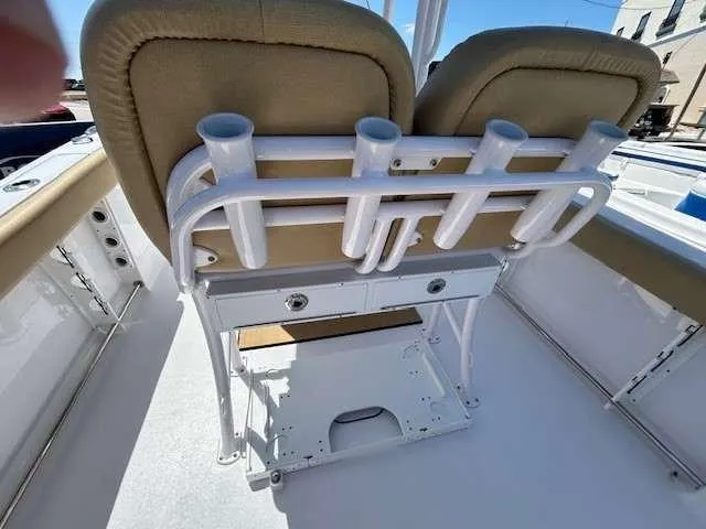 Slide: The Image of 2023 Sportsman 232 Open boat interior with rod holders and cushioned seating. - 14