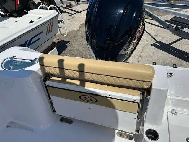 Slide: The Image of 2023 Sportsman 232 Open boat with tan seating and powerful outboard motor. - 15