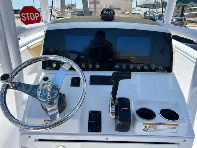 Slide: The Image of 2023 Sportsman 232 Open boat dashboard with steering wheel and dual displays. - 17