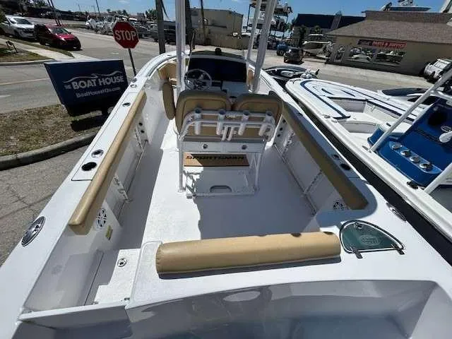 Slide: The Image of 2023 Sportsman 232 Open boat interior with seating and console, displayed at a dealership. - 4