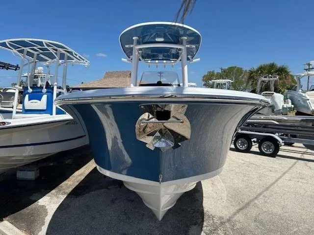 Slide: The Image of 2023 Sportsman 232 Open boat, blue hull, parked on a trailer under clear sky. - 6