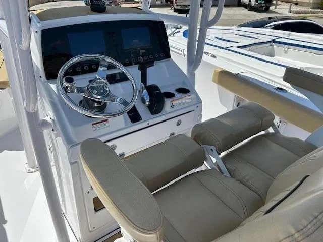 Slide: The Image of 2023 Sportsman 232 Open boat cockpit with steering wheel and dual seats. - 9