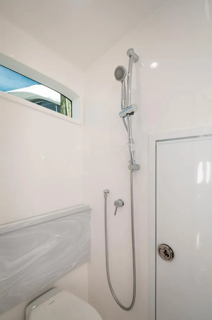 Slide: The Image of 2022 Valhalla Boatworks V46 Center Console bathroom with modern shower. - 13