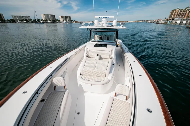 Slide: The Image of 2022 Valhalla Boatworks V46 Center Console on calm waters with luxurious seating. - 28