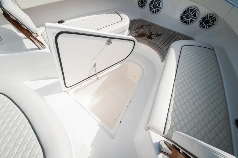 Slide: The Image of 2022 Valhalla Boatworks V46 Center Console with open storage compartment and cushioned seating. - 29