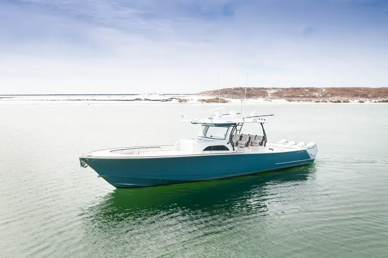 Slide: The Image of 2022 Valhalla V46 Center Console boat on calm water, clear sky background. - 37