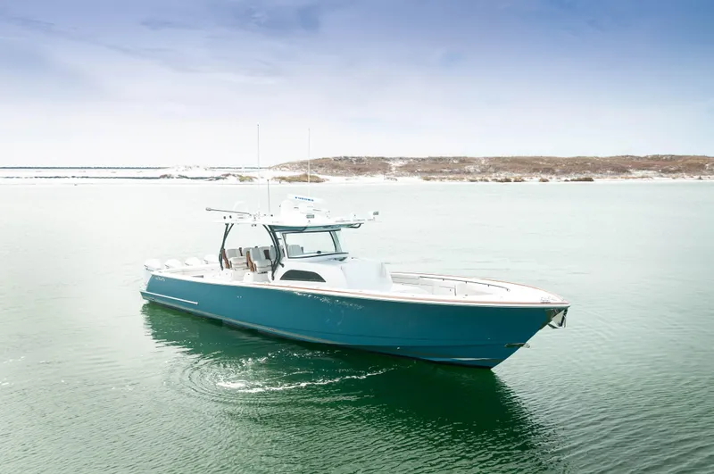 Slide: The Image of 2022 Valhalla V46 Center Console boat on calm water, clear sky background. - 38