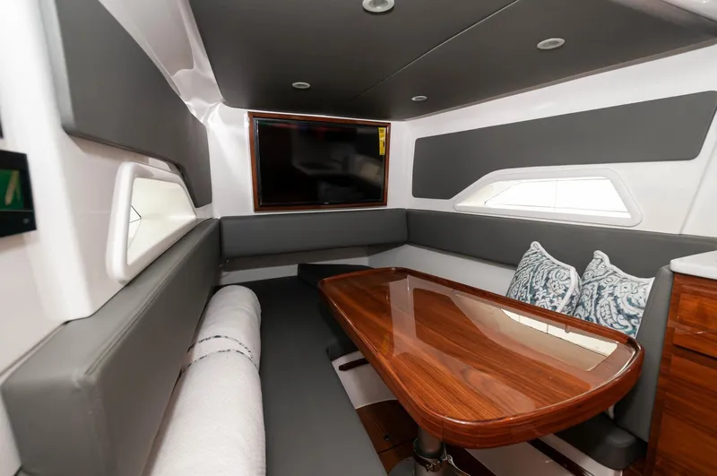 Slide: The Image of Interior of 2022 Valhalla Boatworks V46 Center Console with dining area and TV. - 5