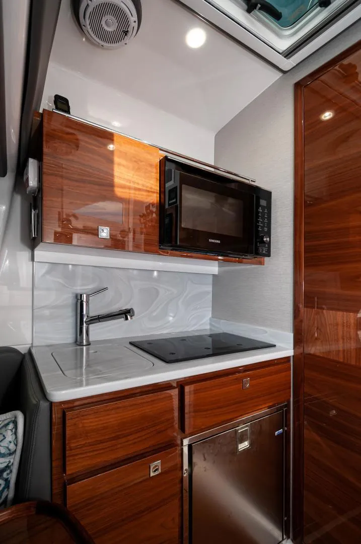 Slide: The Image of 2022 Valhalla Boatworks V46 Center Console galley with microwave and sink. - 9